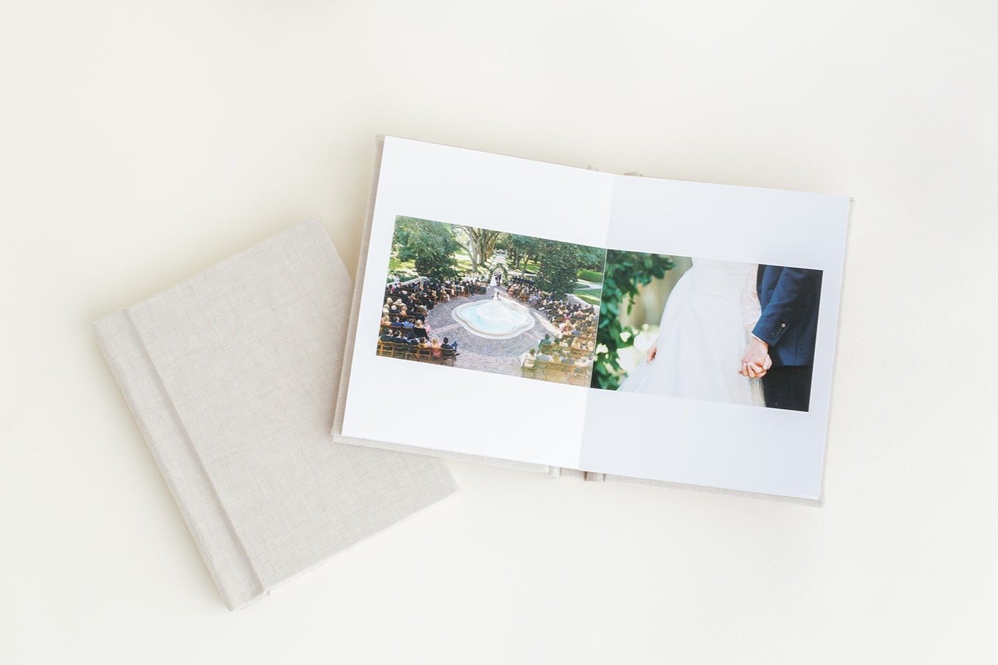 Wedding album with the pages flipped open. On the left displays a wedding ceremony and the right page displays the bride and groom holding hands