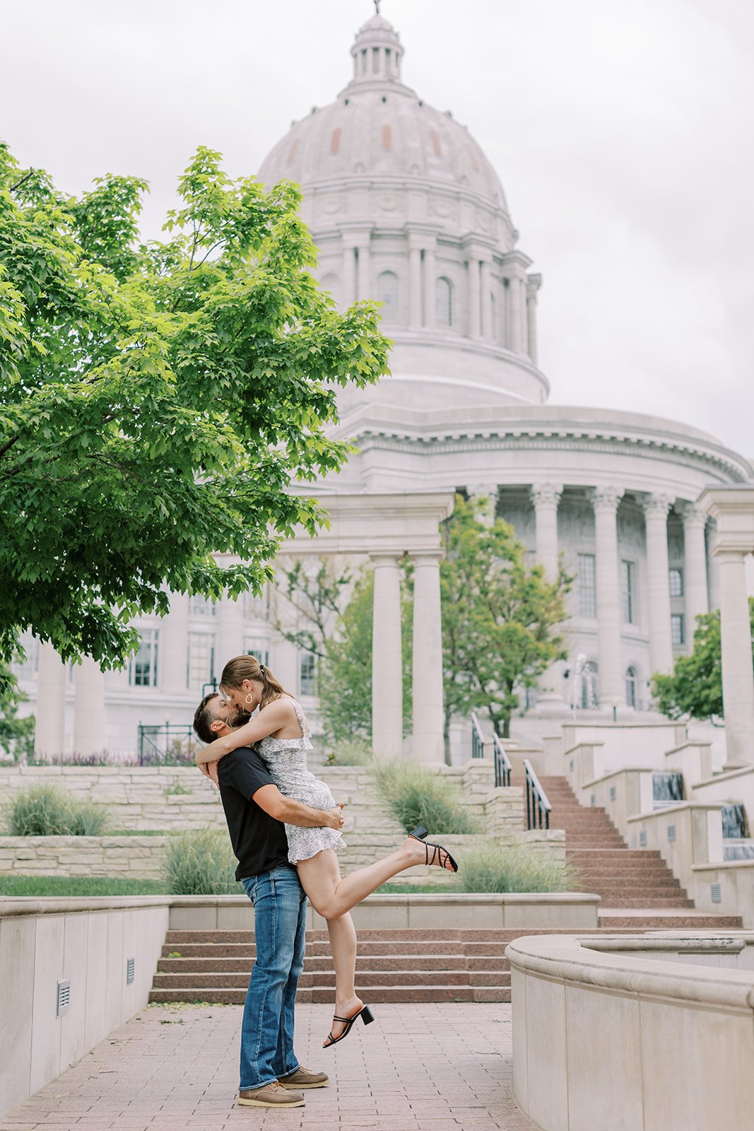 A bride and groom to be posting for their spring engagement session at the Missouri Capitol in Jefferson City Missouri