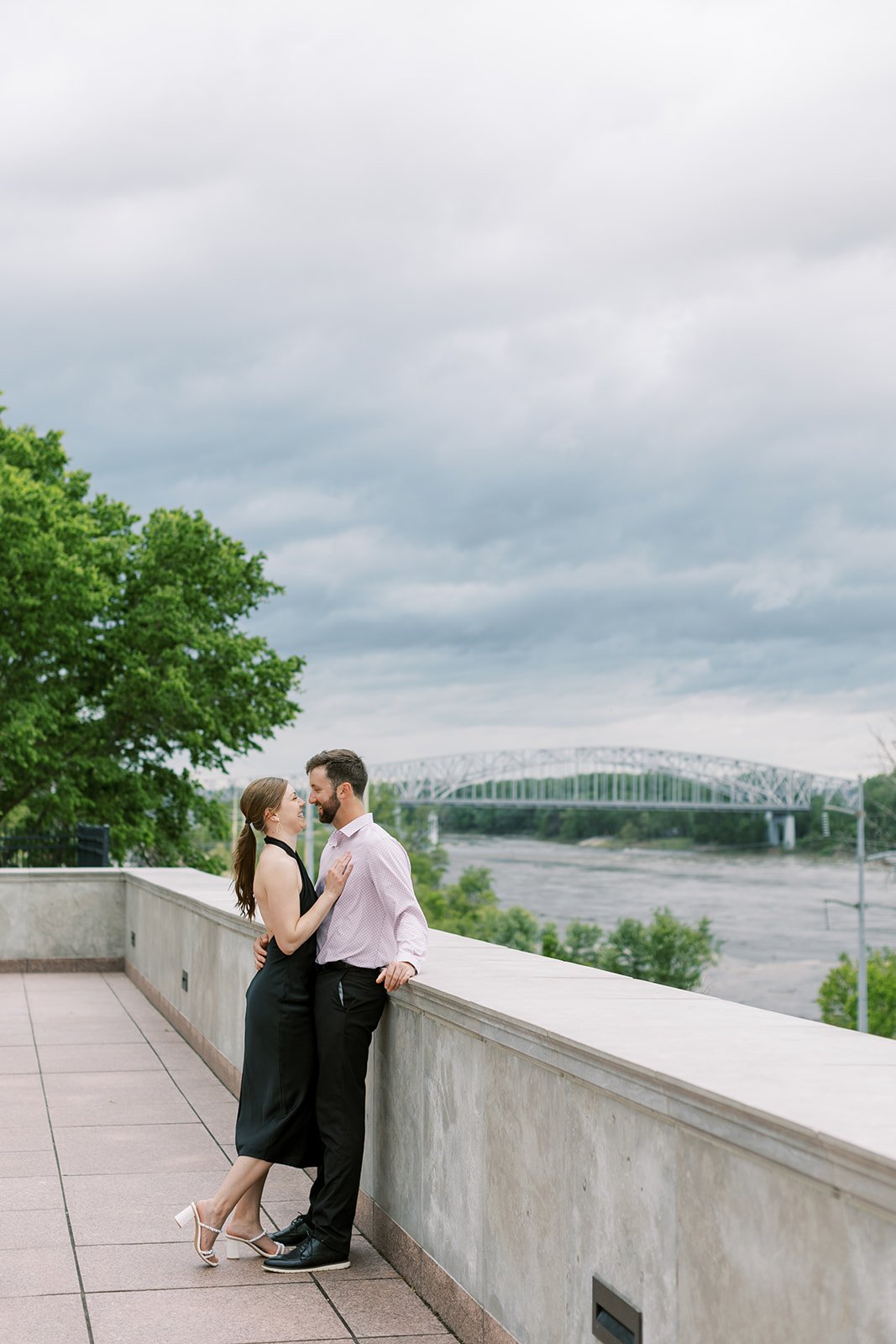A couple posing in Jefferson City Missouri during their spring engagement session by the Missouri Capitol.